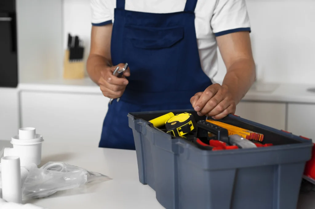 Repair technician organizing tools in toolbox before appliance service in Seattle