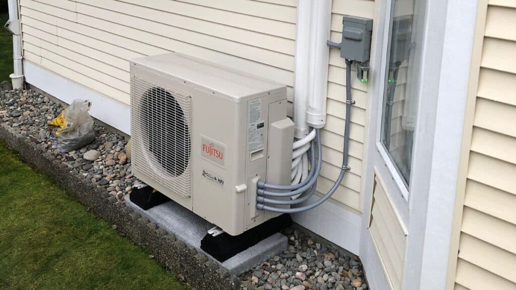 Fujitsu outdoor heat pump system installed on a residential home for energy-efficient heating and air conditioning