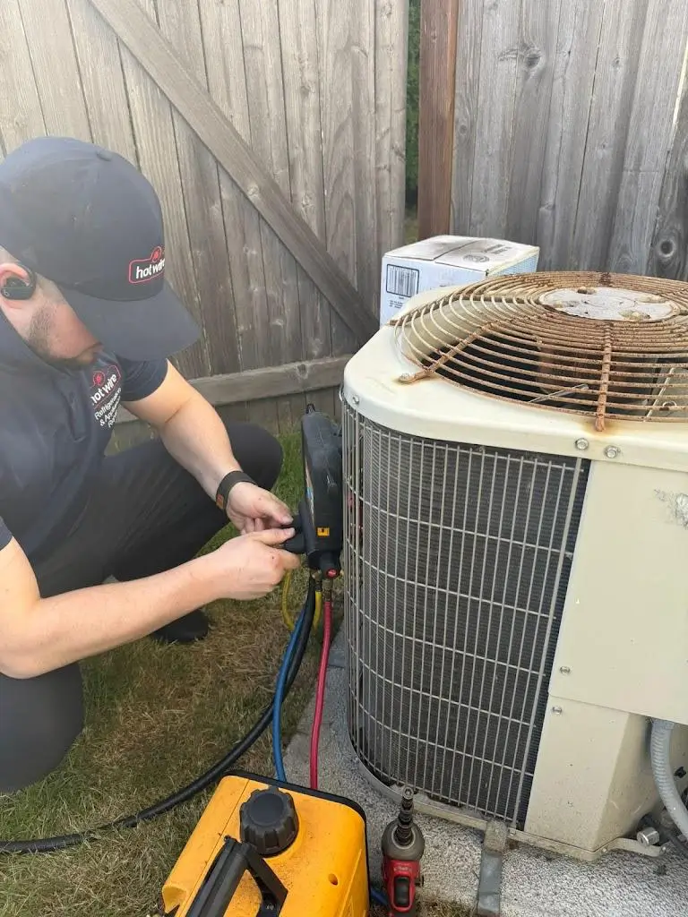 Hotwire technician repairing residential heat pump in Seattle, WA