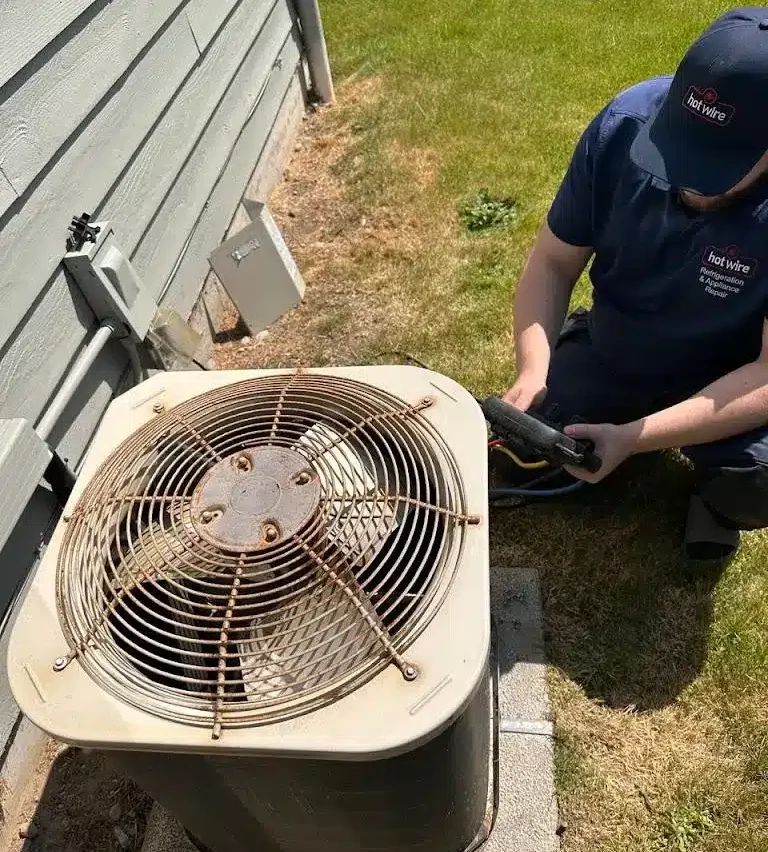 Hotwire technician preparing residential heat pump for winter in Seattle, WA