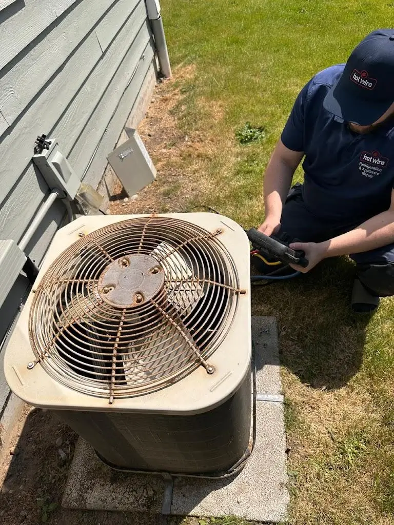 Hotwire technician preparing residential heat pump for winter in Seattle, WA